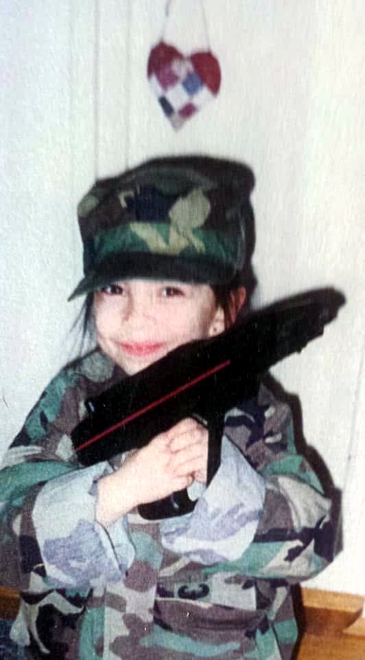 Jennifer as a small child in Merced, wearing her father's Army camouflage jacket and cap.