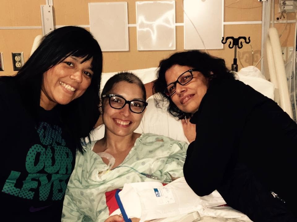 Jennifer in her hospital bed with her mother Lisa and her aunt Rosanne, all three of them smiling.
