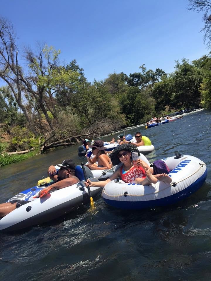 Jennifer floating down the Merced River in an inner tube on a summer day.