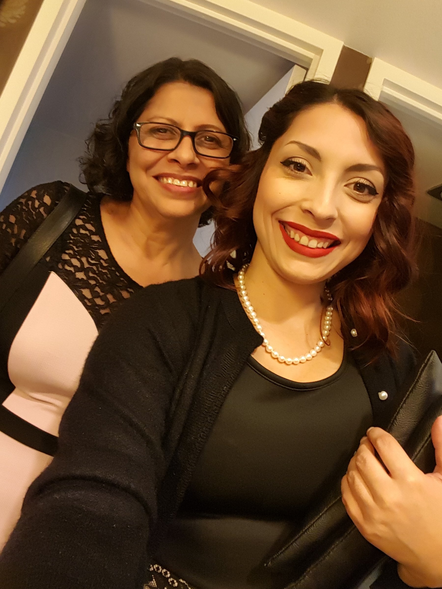 Jennifer with her mother Lisa, both smiling, Jennifer wearing pearls and red lipstick.